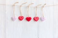 ValentineÃ¢â¬â¢s Day. Sewed pillow hearts row border on red and white clothespins at rustic Royalty Free Stock Photo